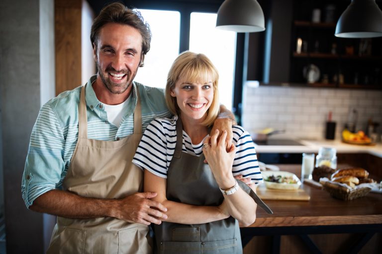 happy couple cooking together husband and wife in 57QN4Q3