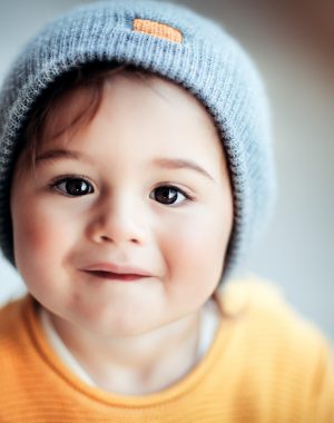 Portrait of a cute happy smiling little baby wearing stylish warm clothes, kids fashion, trendy look in autumn season for boys